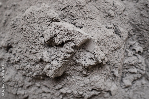 Dry cement in the form of gray powder. For repair and construction
