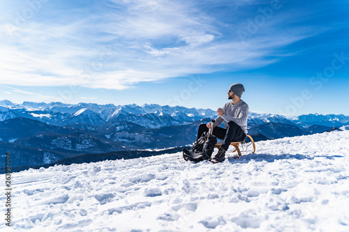 Germany, Bavaria, Brauneck, man in winter in the mountains having a break