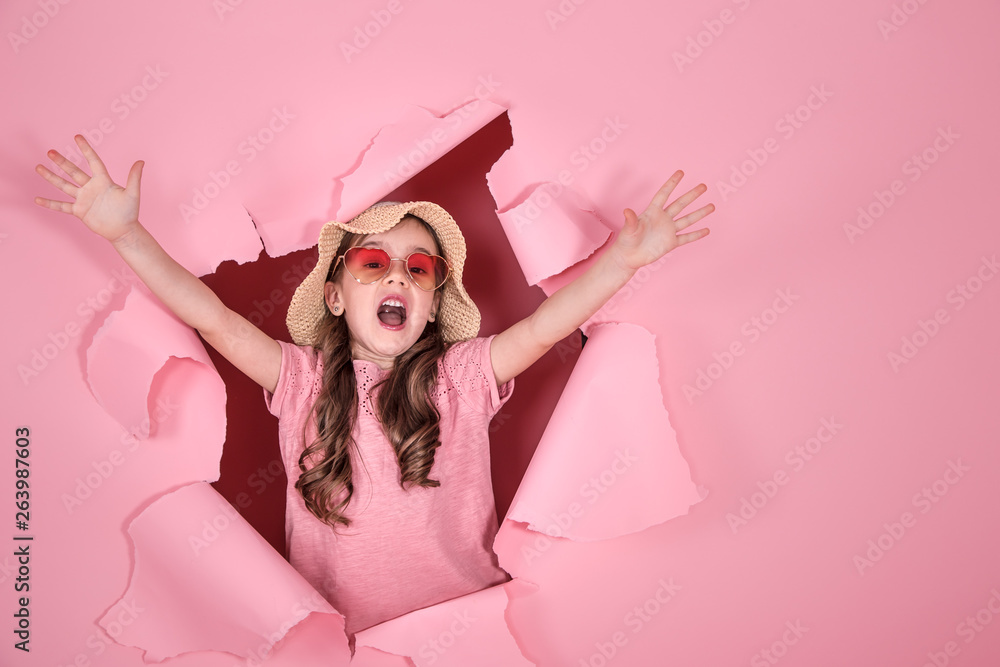 funny little girl with glasses on colored background
