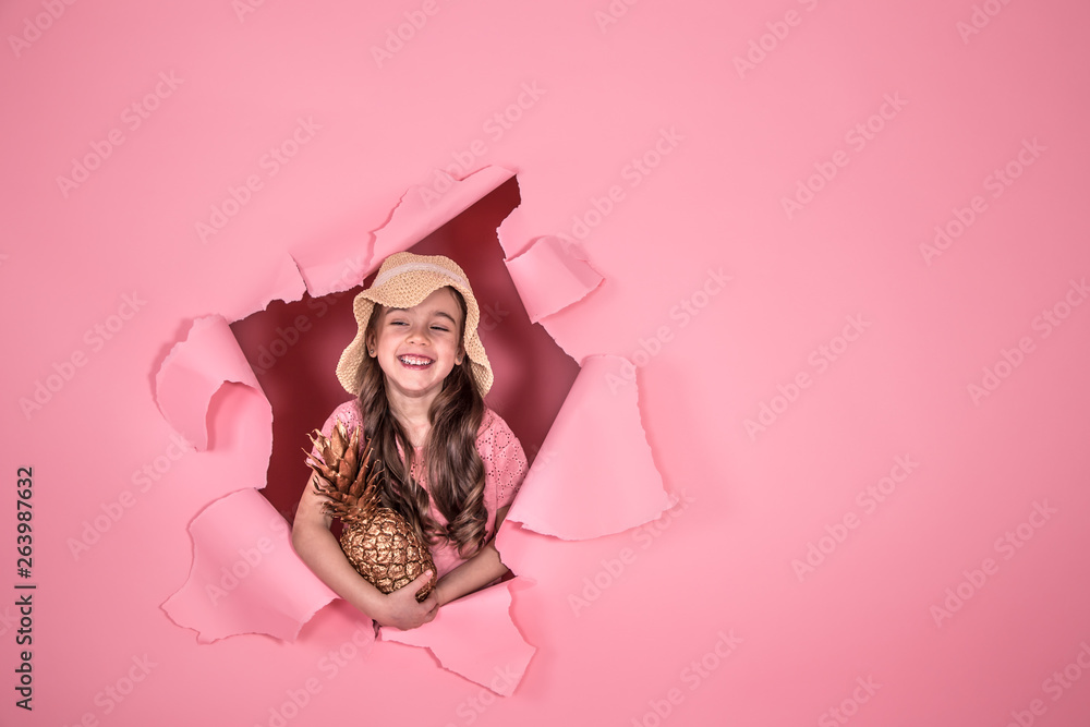 Fototapeta premium Funny little girl with pineapple on colored background
