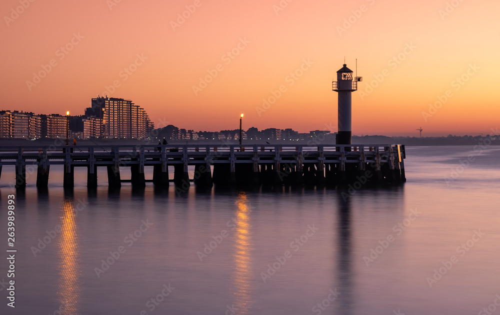 Long exposure image of the Nieuwpoort pier and lighthouse at sunset