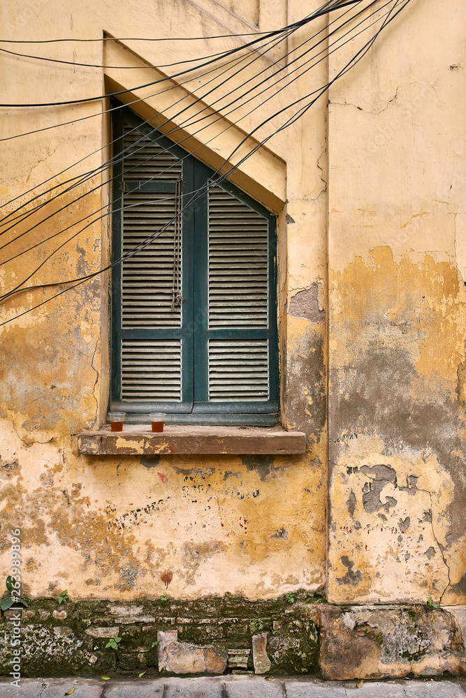 Exterior of vintage vietnamese house with shabby wall