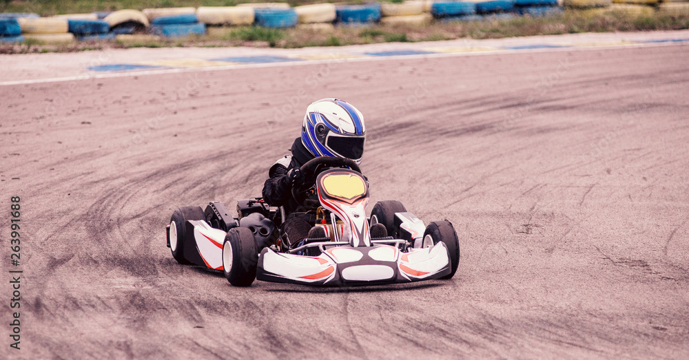Child drives in go-kart on track during competition