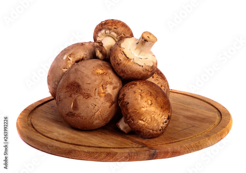 royal large champignon on a wooden chopping round board. on a white background