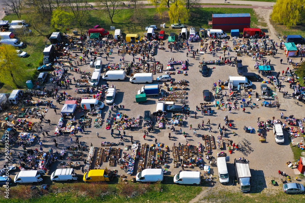 Aerial view on flea market with miscellaneous items and crowds of buyers and seller's makeshift stands