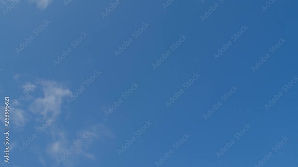 A cute 9-10 years old girl with curly hair having fun jumping at trampoline blue sky background, 4k slow motion low angle view A cute 9-10 years old girl with curly hair having fun jumping at trampoline blue sky background, 4k slow motion low angle view