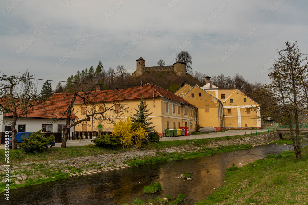 Obraz premium Brumov town and castle in east Moravia in spring cloudy day