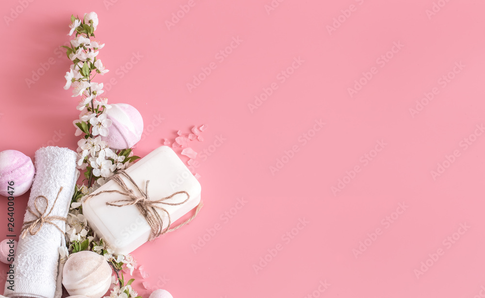Spa still life on pink background with spring flowers