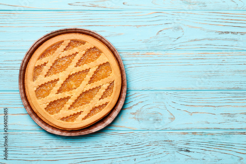 tasty cake with jam on а blue wooden background