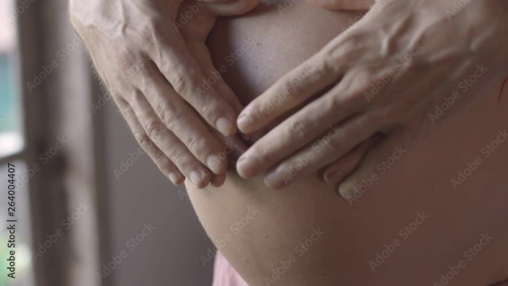 Mom and dad hands on pregnant tummy. Pregnant couple caressing pregnant belly. Happy family. pregnancy, motherhood, maternity, people and expectation concept Mom and dad hands on pregnant tummy. Pregnant couple caressing pregnant belly. Happy family. pregnancy, motherhood, maternity, people and expectation concept