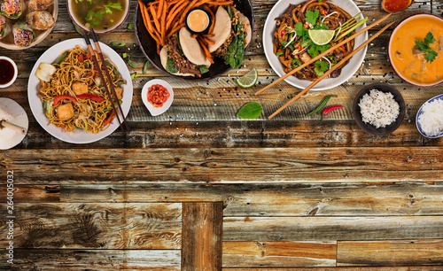 Asian food background with various ingredients on rustic wooden table , top view.
