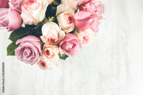pink roses on the wooden desk © ARAMYAN