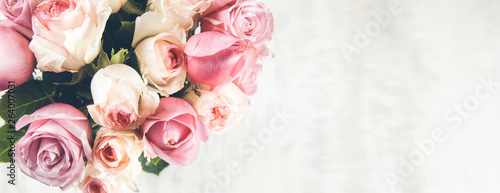 pink roses on the wooden desk
