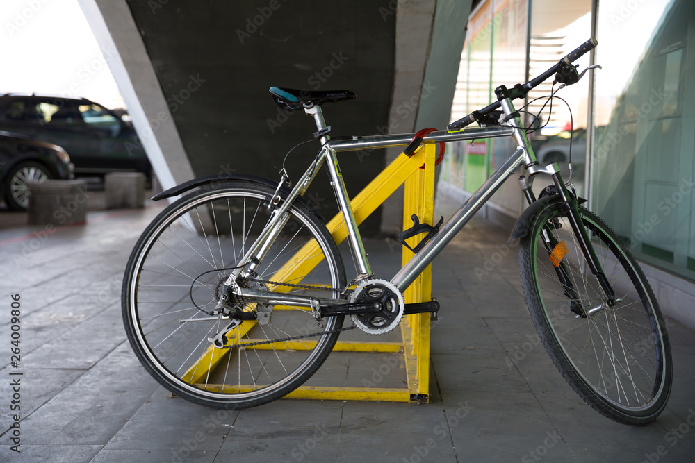 Photo of parked bicycle under the stairs for graphic and web design, for website or mobile app. Photo of parked bicycle under the stairs for graphic and web design, for website or mobile app.
