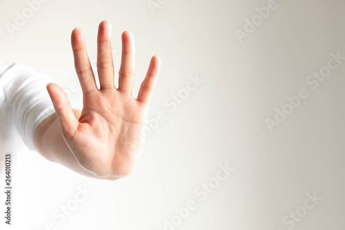 woman gesturing a hand showing five fingers meaning stop and warning to do not do something.