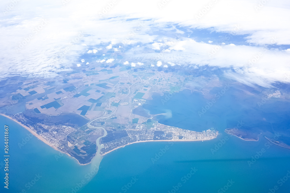 Beautiful landscape of earth and blue sea, the view from the plane during the flight Beautiful landscape of earth and blue sea, the view from the plane during the flight
