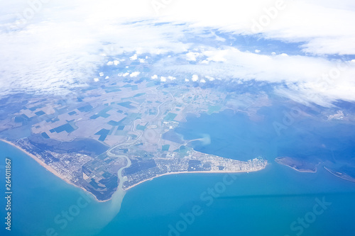 Beautiful landscape of earth and blue sea, the view from the plane during the flight
