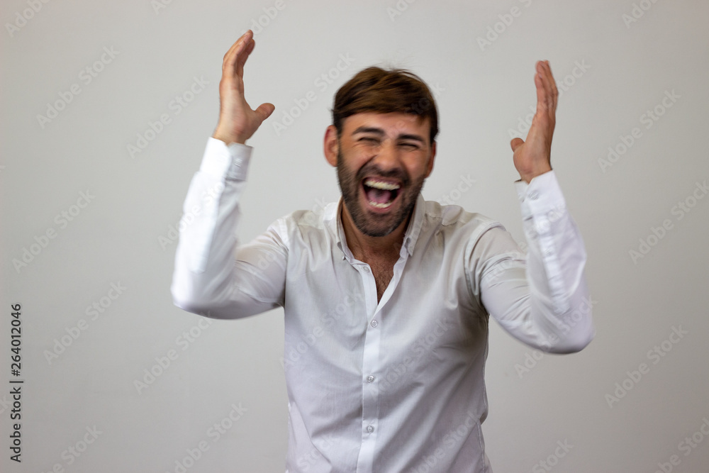 Fashion portrait of handsome young man with brown hair looking euphoric, looking at the camera. Isolated on white background. Fashion portrait of handsome young man with brown hair looking euphoric, looking at the camera. Isolated on white background.