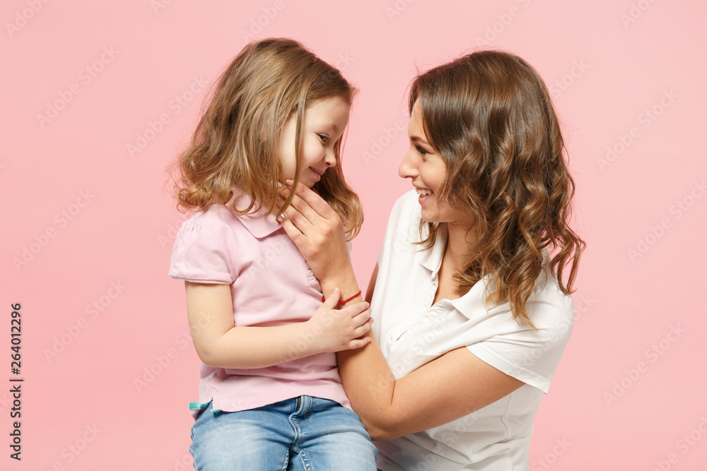 Woman in light clothes have fun with cute child baby girl. Mother, little kid daughter isolated on pastel pink wall background, studio portrait. Mother's Day, love family, parenthood childhood concept Woman in light clothes have fun with cute child baby girl. Mother, little kid daughter isolated on pastel pink wall background, studio portrait. Mother's Day, love family, parenthood childhood concept
