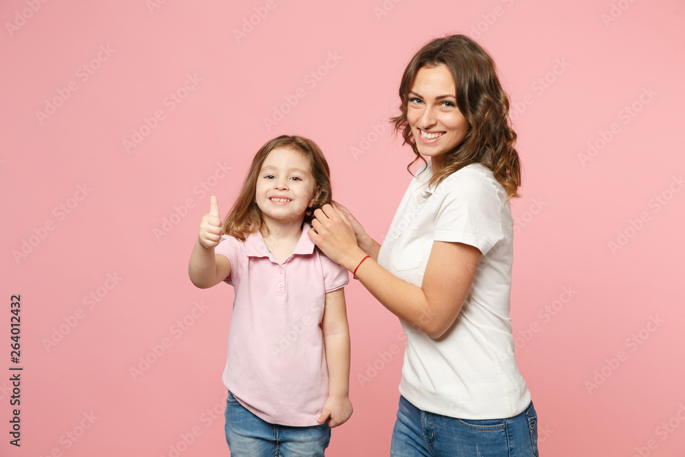 Woman in light clothes have fun with cute child baby girl. Mother, little kid daughter isolated on pastel pink wall background, studio portrait. Mother's Day, love family, parenthood childhood concept Woman in light clothes have fun with cute child baby girl. Mother, little kid daughter isolated on pastel pink wall background, studio portrait. Mother's Day, love family, parenthood childhood concept