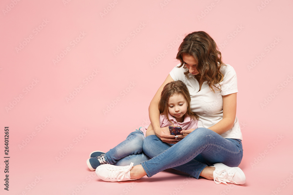 Woman in light clothes have fun with cute child baby girl. Mother, little kid daughter isolated on pastel pink wall background, studio portrait. Mother's Day, love family, parenthood childhood concept Woman in light clothes have fun with cute child baby girl. Mother, little kid daughter isolated on pastel pink wall background, studio portrait. Mother's Day, love family, parenthood childhood concept
