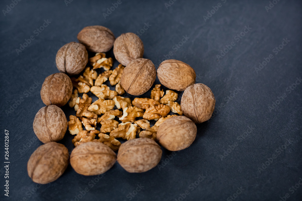 walnut on a gray background in the shape of a heart to the side walnut on a gray background in the shape of a heart to the side