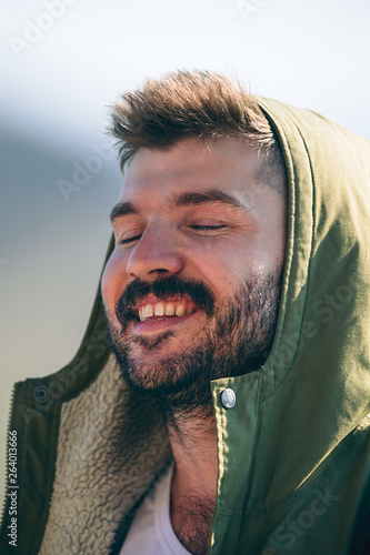 Happy young man with hood on his head. Happiness concept.