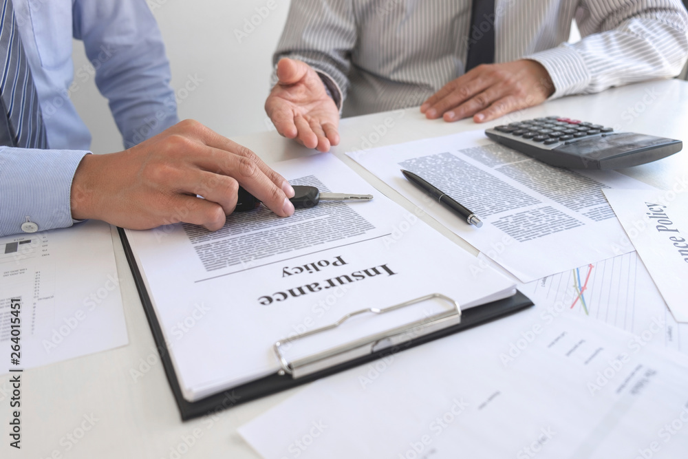 Real estate Sales manager giving keys to customer after signing rental lease contract of sale purchase agreement, concerning mortgage loan offer for and house insurance Real estate Sales manager giving keys to customer after signing rental lease contract of sale purchase agreement, concerning mortgage loan offer for and house insurance