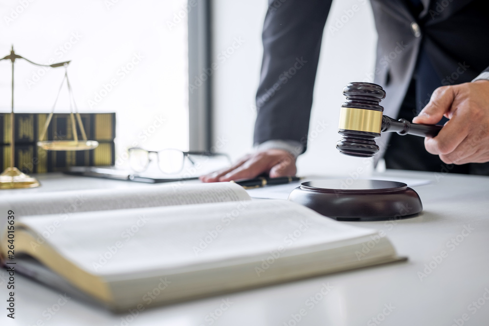 Judge gavel with Justice lawyers, Counselor in suit or lawyer working on a documents in courtroom, Legal law, advice and justice concept Judge gavel with Justice lawyers, Counselor in suit or lawyer working on a documents in courtroom, Legal law, advice and justice concept