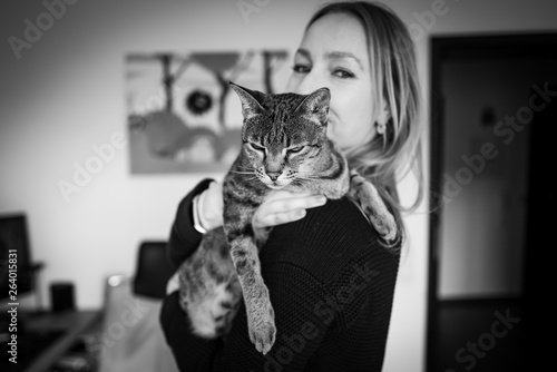 Wall Mural A cute Savannah cat with blonde girl