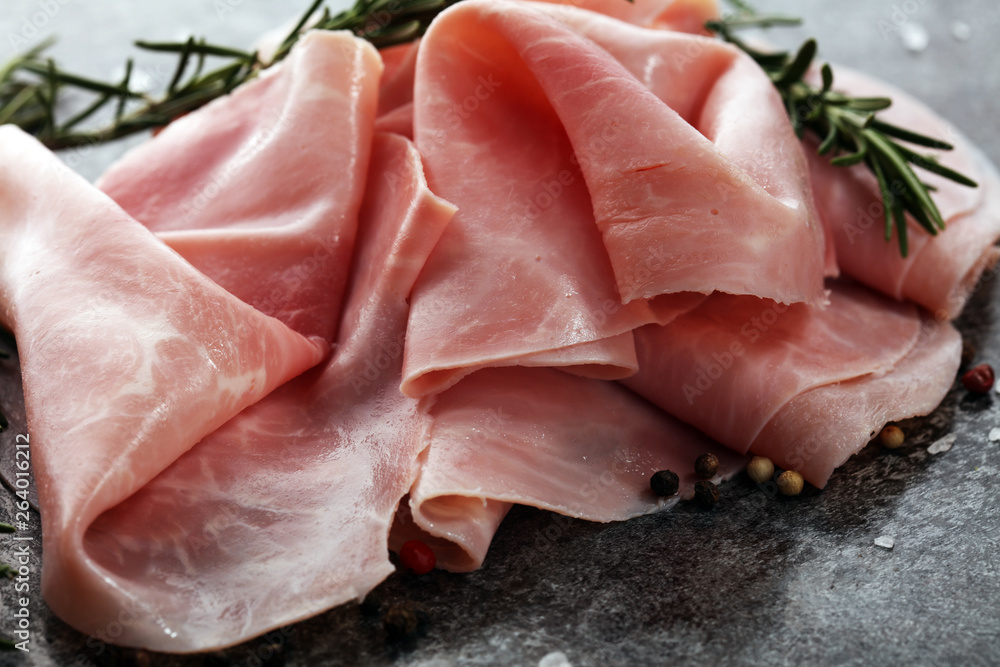 Sliced ham on wooden background. Fresh prosciutto cotto. Pork ham sliced. Sliced ham on wooden background. Fresh prosciutto cotto. Pork ham sliced.