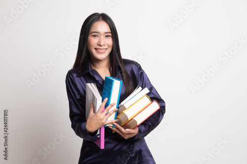 Young Asian woman studying with may books.