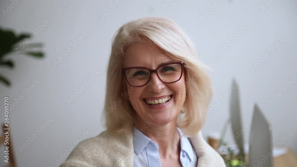 Happy mature businesswoman in glasses smiling looking at camera Happy mature businesswoman in glasses smiling looking at camera