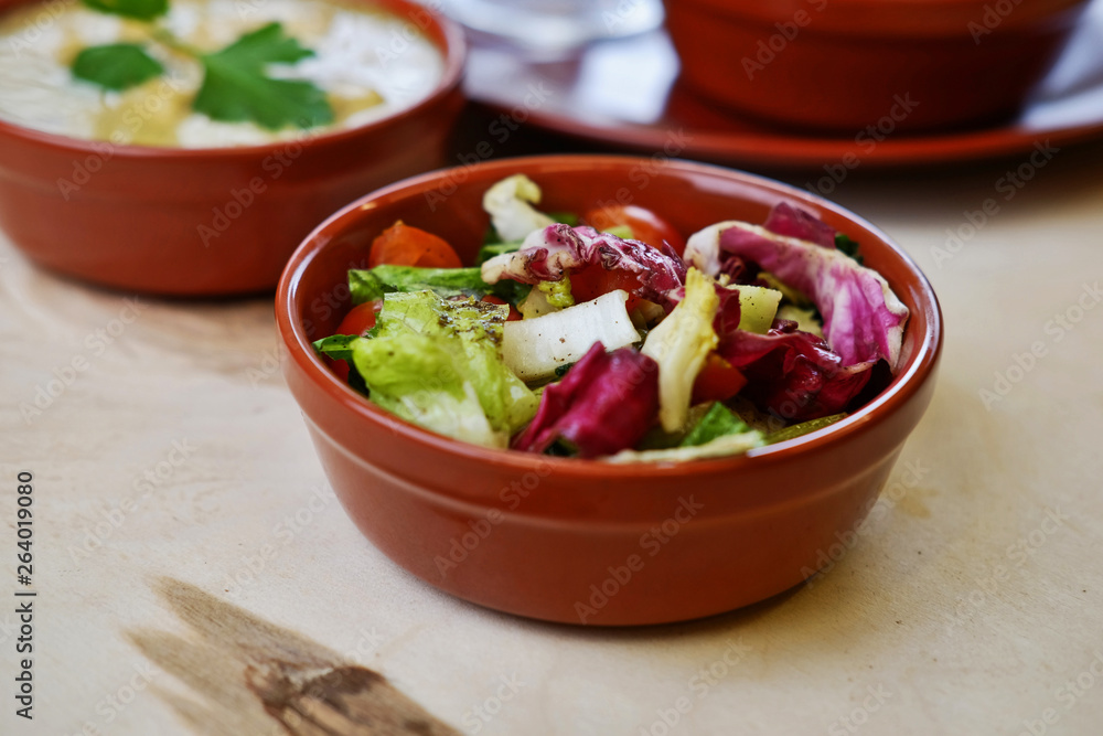 Closeup photo of vegetable salat in bowl with traditional indian dishes at background. Closeup photo of vegetable salat in bowl with traditional indian dishes at background.
