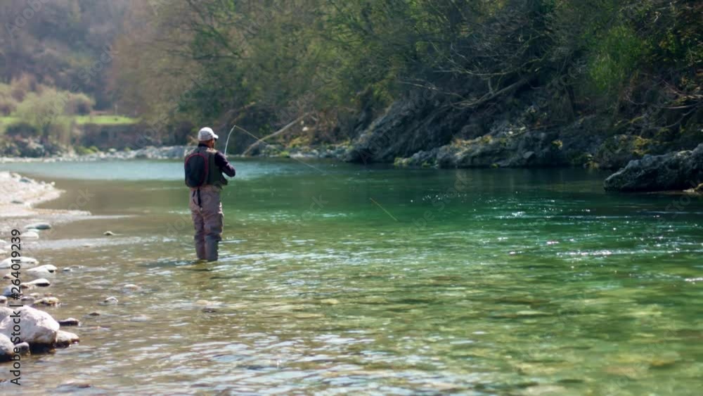Flyfishing Man Relaxing and catches fishes Flyfishing Man Relaxing and catches fishes