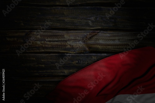 cute dark picture of Indonesia flag with big folds on old wood with free space for your text - any feast flag 3d illustration..