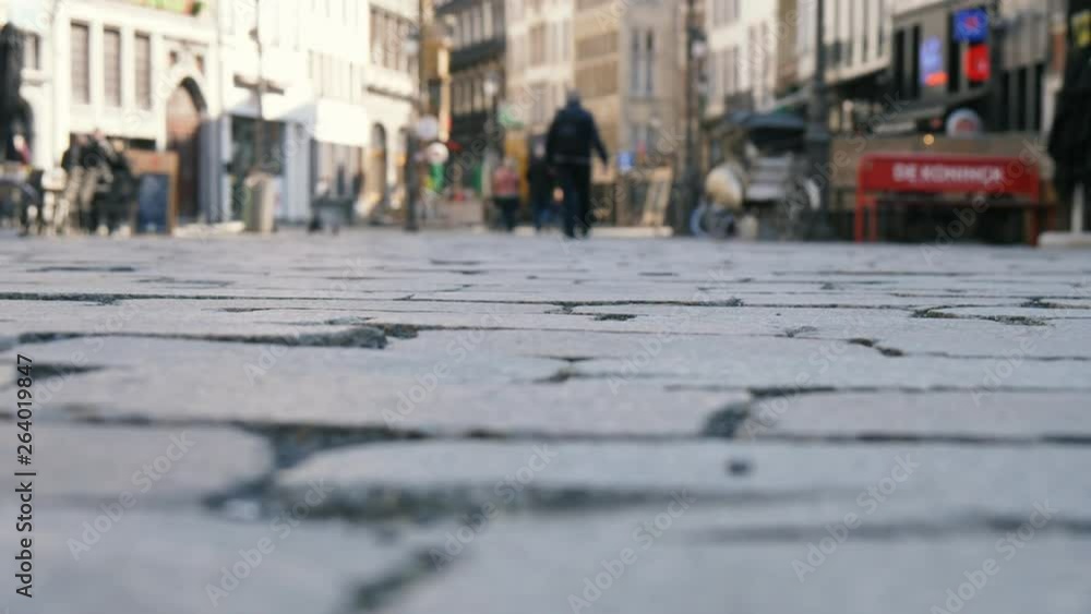 People walking on a cobblestone street with historic buildings in Belgium in slo-mo People walking on a cobblestone street with historic buildings in Belgium in slo-mo