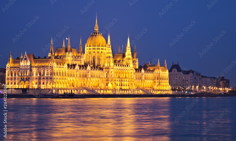 Budapest Parliament at night with reflection in danube.