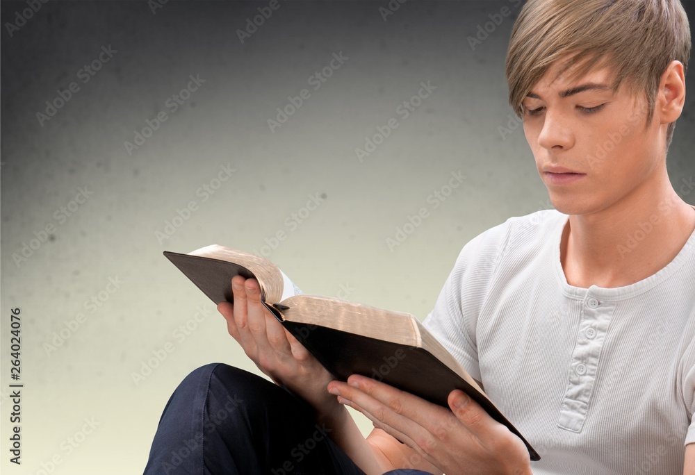 Obraz na plátně Man reading Bible on  background