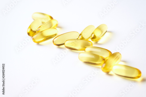 Fish oil capsules with omega 3 on white background. Concept for a healthy dietary supplementation. Immune System Support. Close up. Copy space.