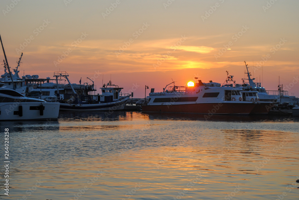 Ships, boats on port. Sunset in the port of Naxos island in Greece