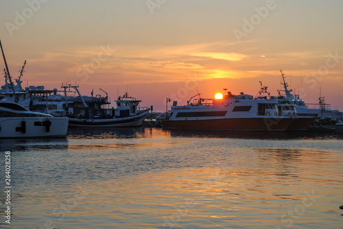 Ships, boats on port. Sunset in the port of Naxos island in Greece