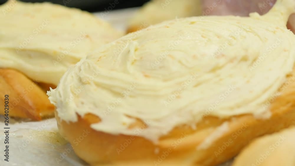 orange roll being placed on tray with other rolls slow motion. Slow motion clip of orange rolls on tray. orange roll being placed on tray with other rolls slow motion. Slow motion clip of orange rolls on tray.
