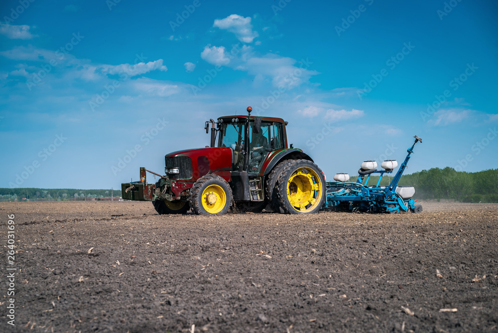 A large tractor in the field prepares a land for planting A large tractor in the field prepares a land for planting