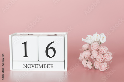 November 16th. Day 16 of month. Calendar cube on modern pink background, concept of bussines and an importent event. photo