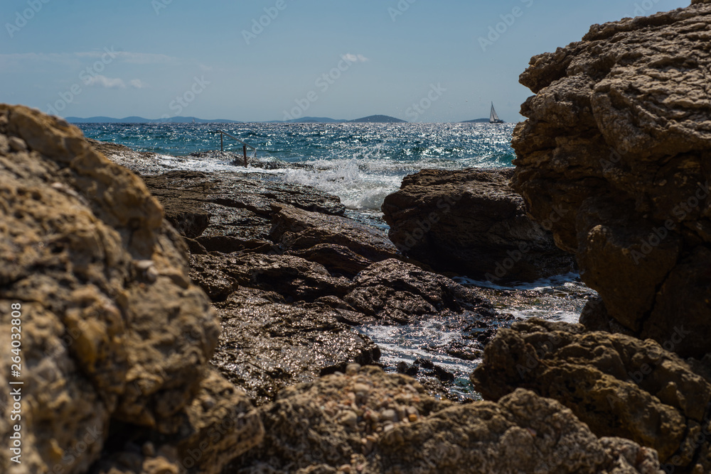 Waves breaking on a stony beach in Murter, Croatia, Dalmatia