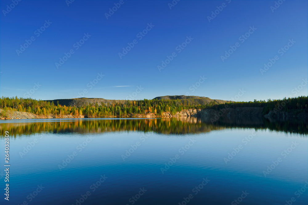 Autumn landscape sunset in the forest near the lake in the Ural Mountains Autumn landscape sunset in the forest near the lake in the Ural Mountains