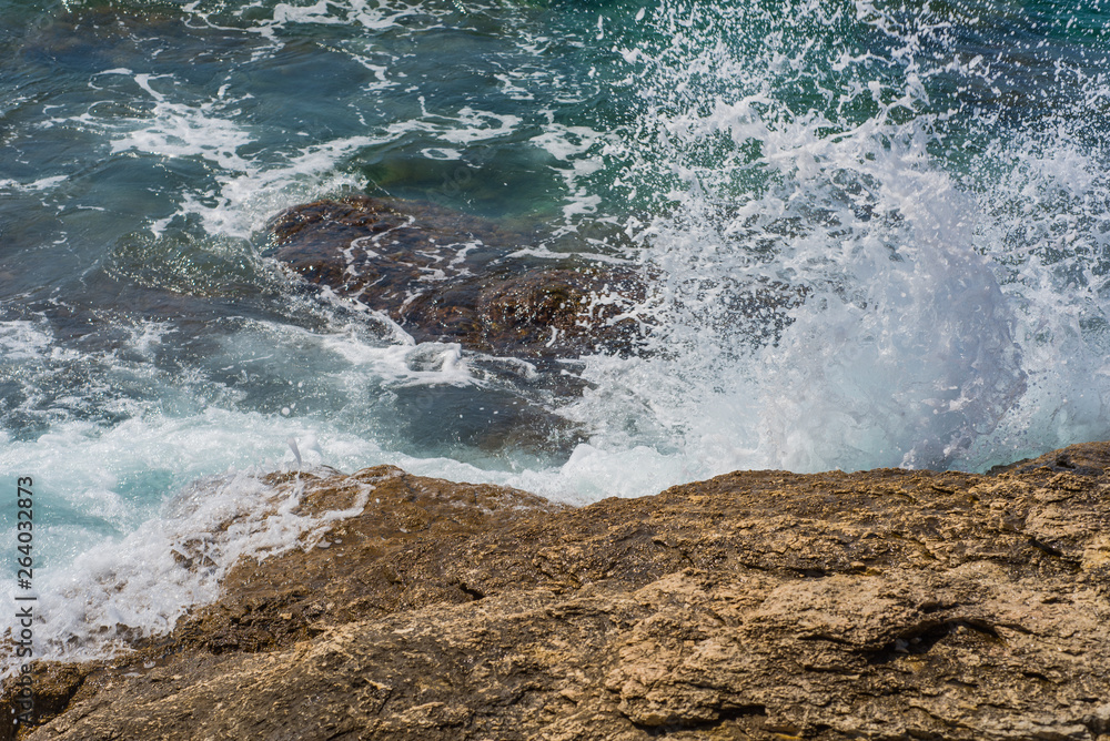 Obraz premium Waves breaking on a stony beach in Murter, Croatia, Dalmatia
