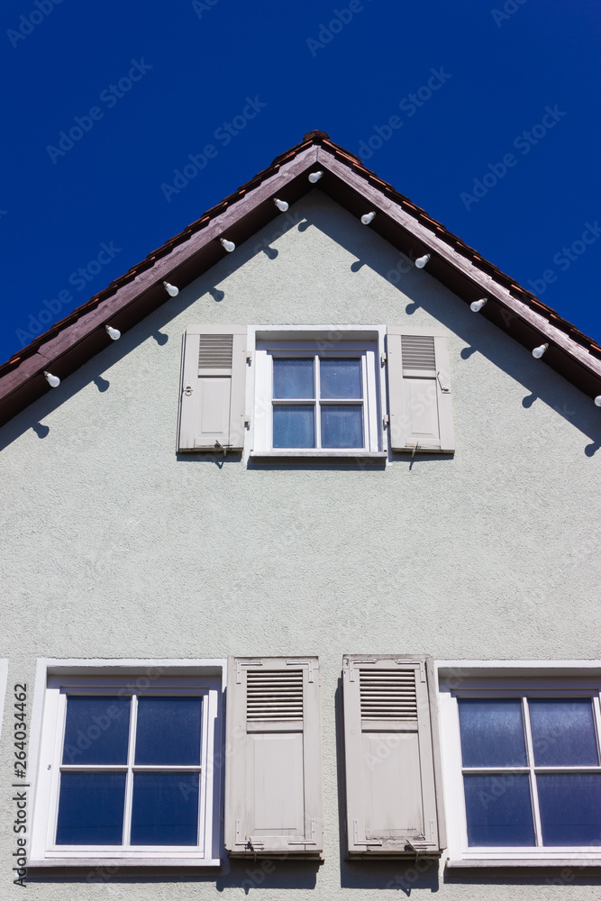 historical house facades and rooftops on blue sky