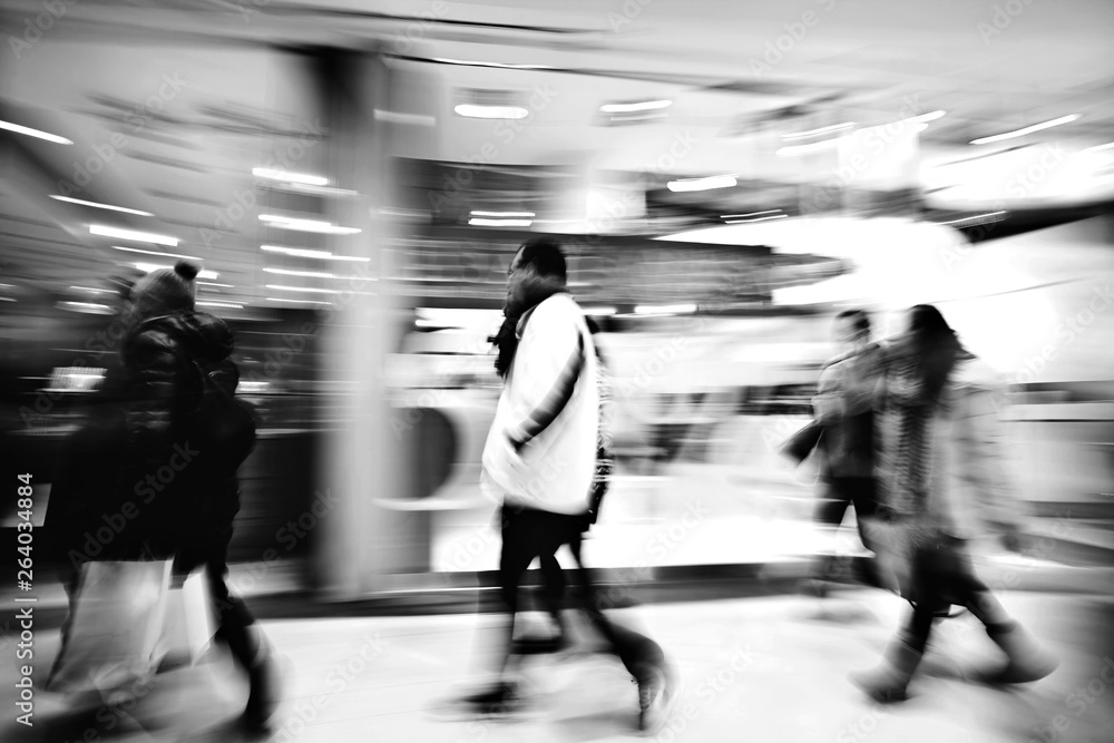 Fototapeta premium A shopper walking against shop window
